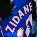 Detailed view of blue soccer jersey featuring a renowned player's name.